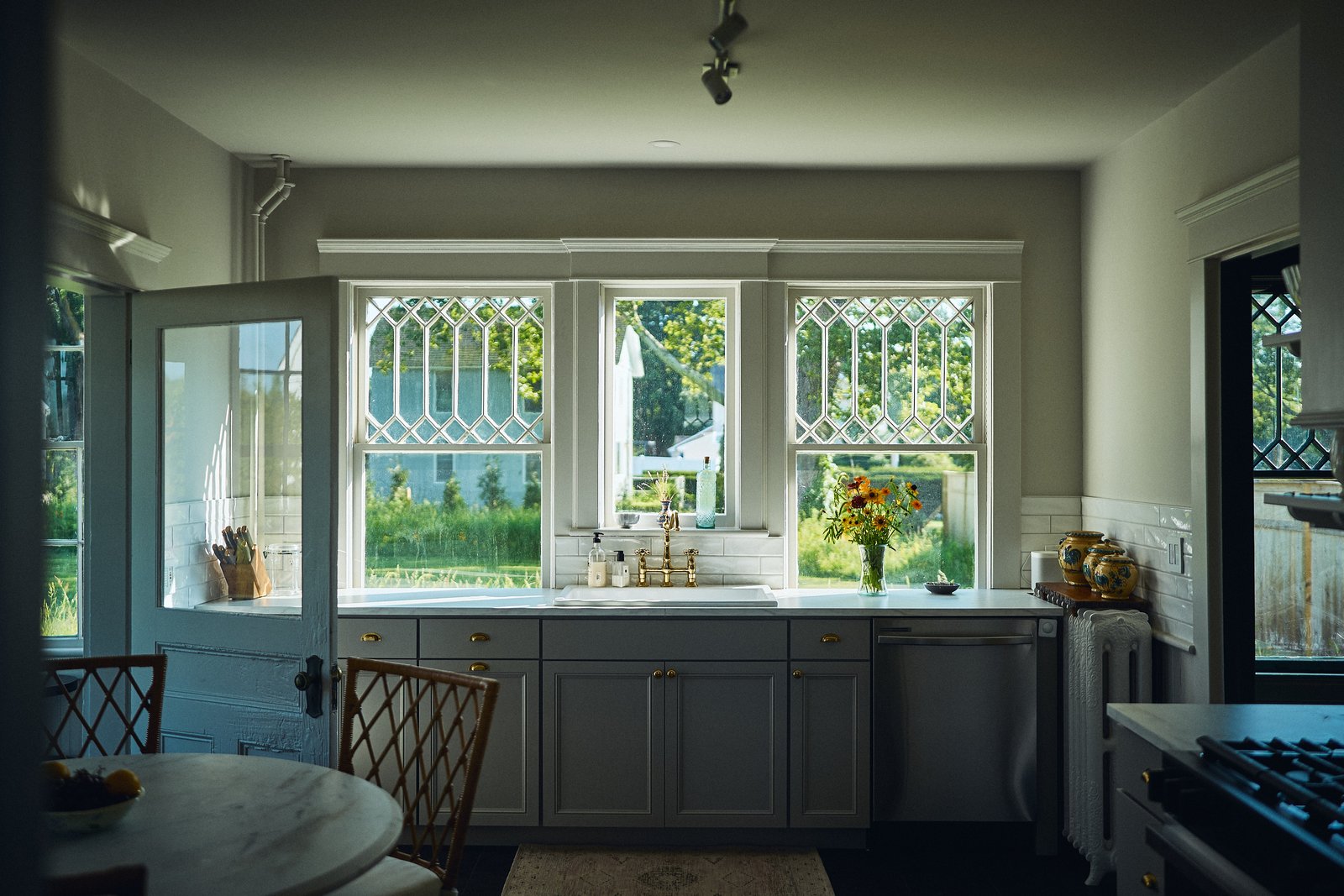 The kitchen with leaded glass windows and farmhouse sink