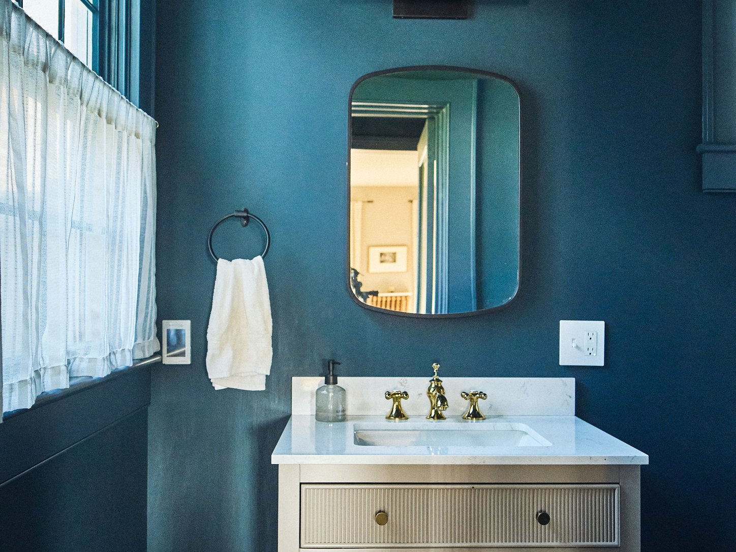 The powder room with brass fixtures